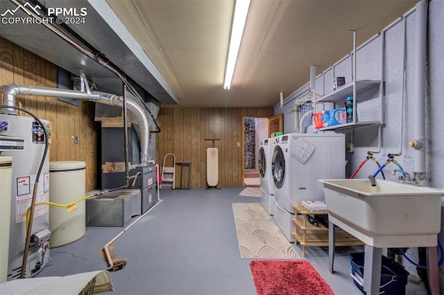 laundry room featuring independent washer and dryer, heating unit, wooden walls, and water heater