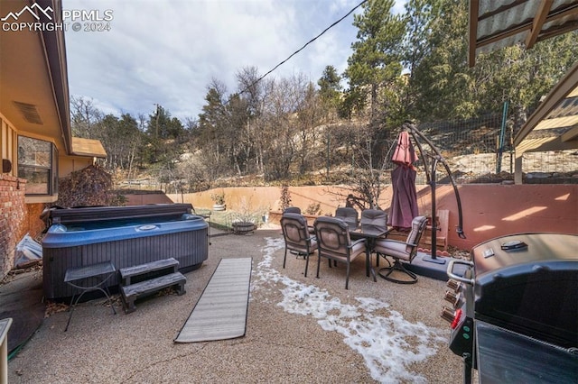 view of patio featuring a grill and a hot tub