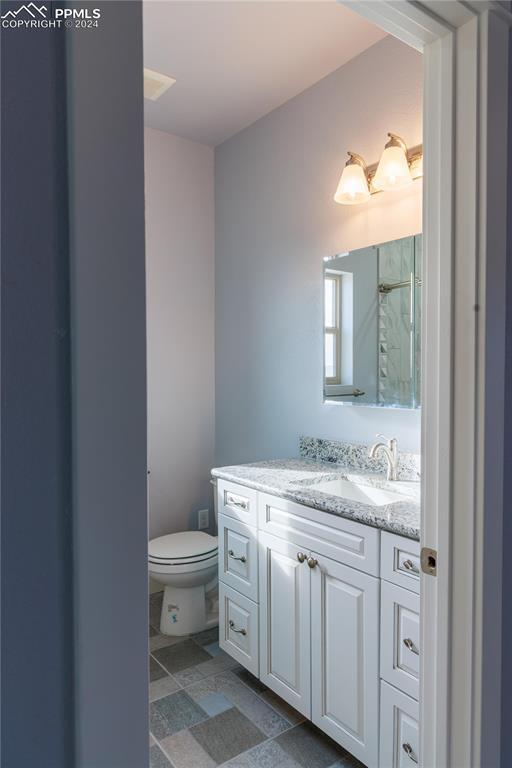 bathroom featuring vanity and toilet