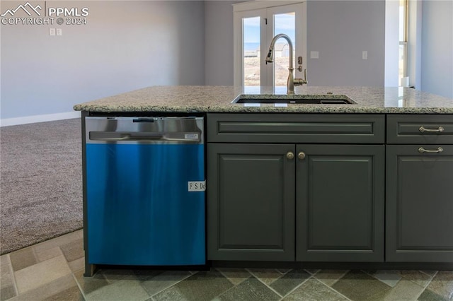 kitchen with carpet, light stone countertops, sink, dishwasher, and a kitchen island