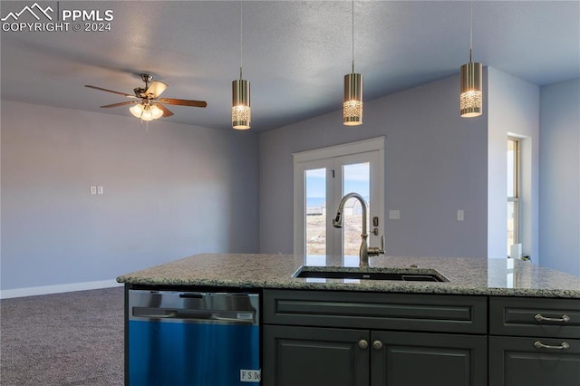 kitchen featuring sink, stainless steel dishwasher, ceiling fan, decorative light fixtures, and carpet floors