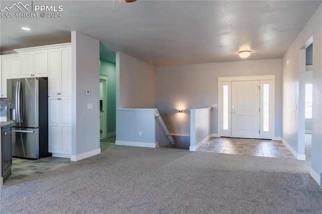 view of carpeted entrance foyer