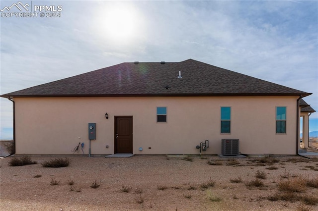 back of house featuring cooling unit