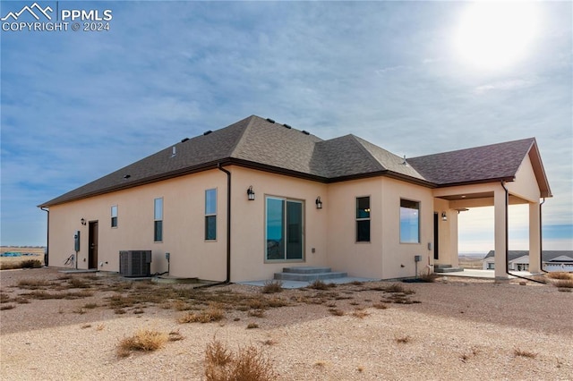 rear view of property featuring central AC