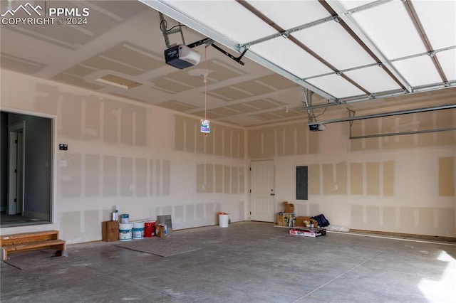 garage with electric panel and a garage door opener