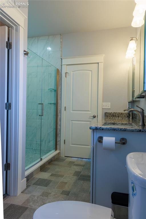 bathroom with vanity, toilet, and walk in shower