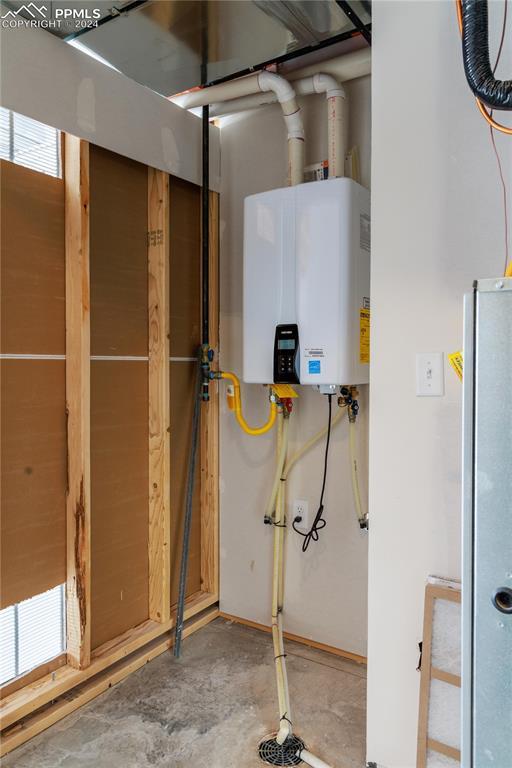 utility room featuring water heater