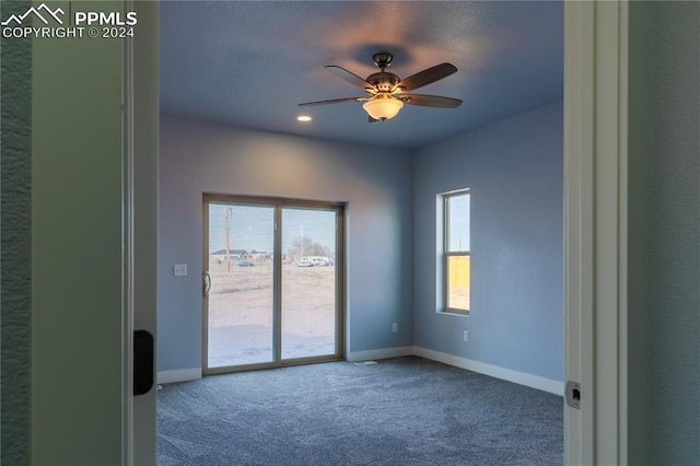 carpeted empty room featuring ceiling fan