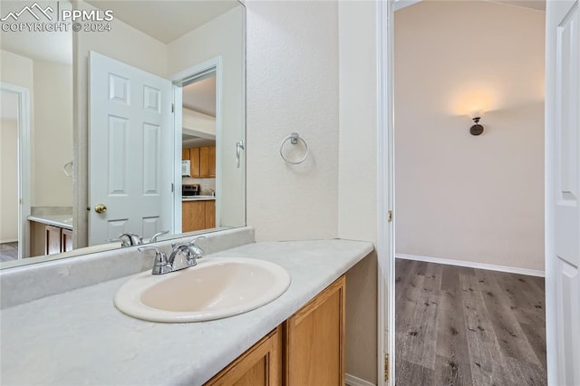 bathroom featuring vanity and hardwood / wood-style flooring