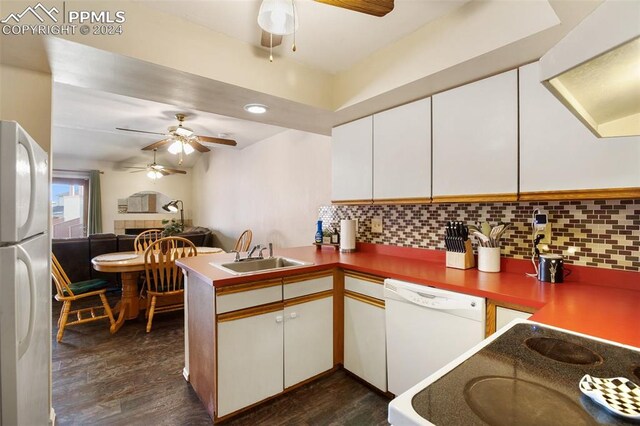 kitchen featuring sink, white cabinets, kitchen peninsula, and white appliances