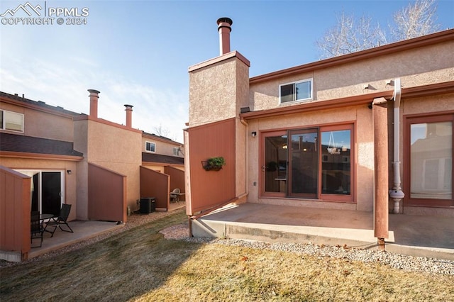 back of property featuring a patio area, cooling unit, and a lawn