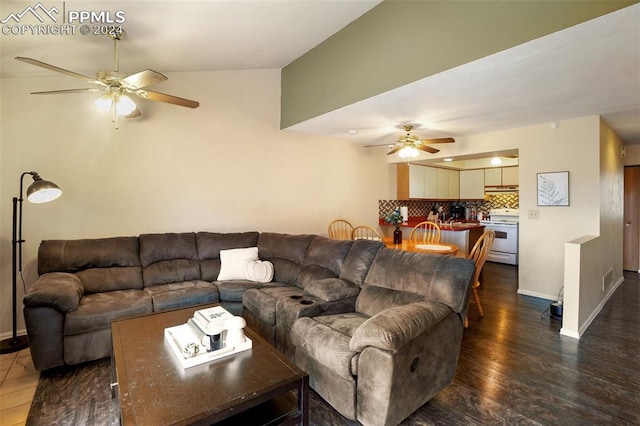 living room with dark wood-type flooring, ceiling fan, and lofted ceiling