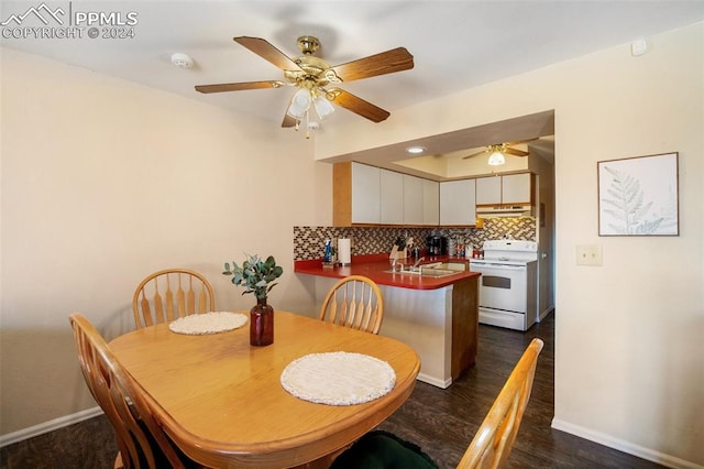 dining room with ceiling fan, sink, and dark hardwood / wood-style floors