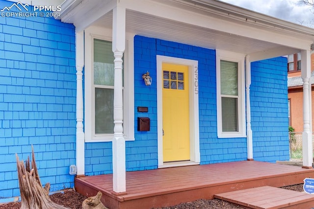 view of exterior entry with covered porch