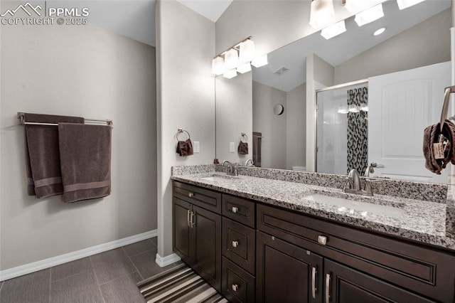 bathroom with a shower with door, vanity, lofted ceiling, and toilet