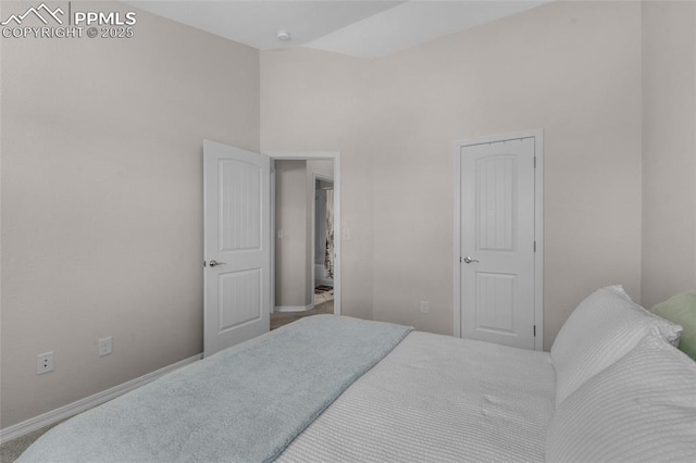 carpeted bedroom with lofted ceiling