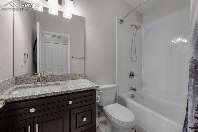 full bathroom with vanity, shower / bath combo, and toilet