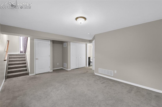 basement featuring light carpet