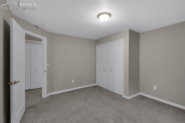 unfurnished bedroom with light carpet and a closet