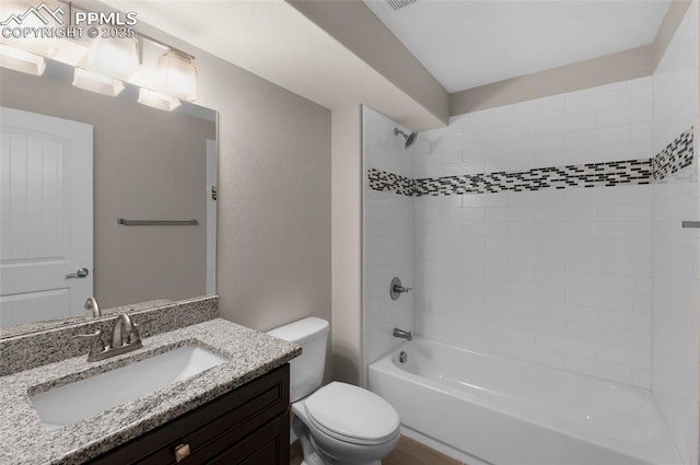 full bathroom with vanity, toilet, and tiled shower / bath