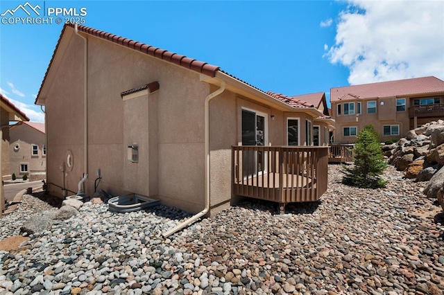 rear view of property featuring a deck