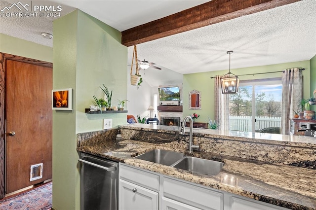 kitchen featuring dishwasher, ceiling fan with notable chandelier, sink, stone countertops, and white cabinetry