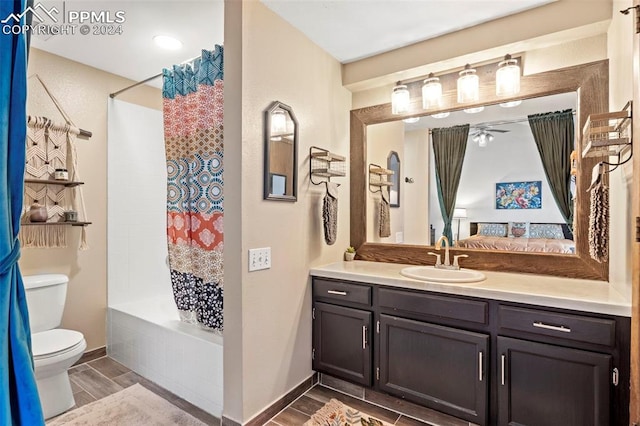 full bathroom featuring vanity, toilet, ceiling fan, and shower / bath combo with shower curtain