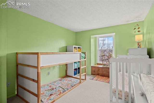 bedroom featuring carpet floors and a textured ceiling