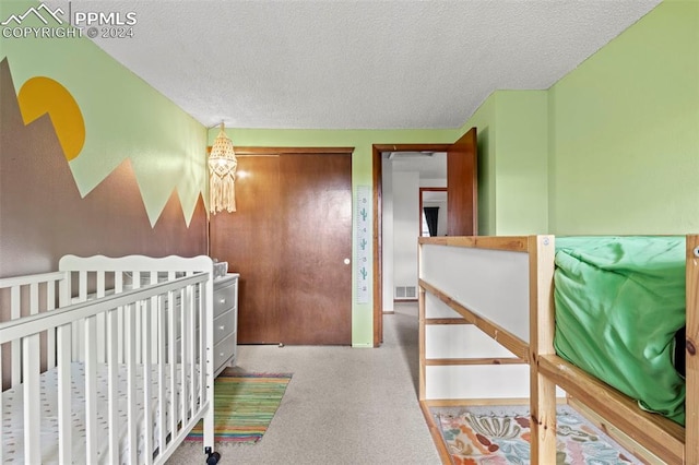 carpeted bedroom with a textured ceiling