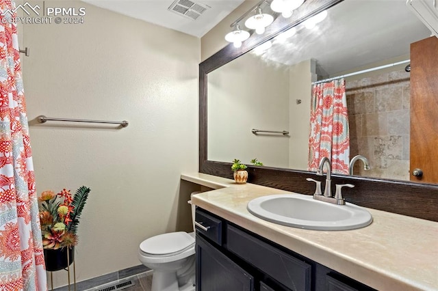 bathroom featuring a shower with shower curtain, tile patterned floors, vanity, and toilet