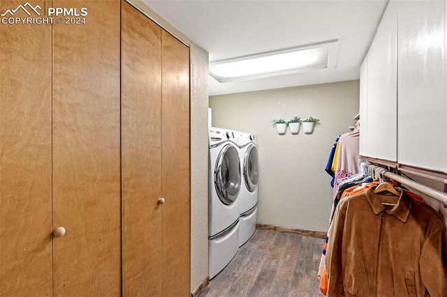 washroom with dark hardwood / wood-style flooring and independent washer and dryer