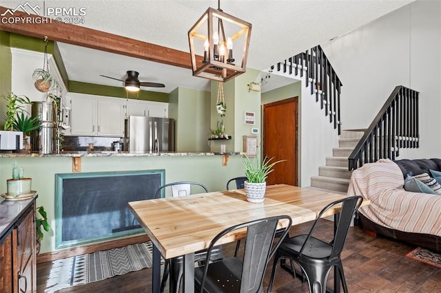 dining area with beamed ceiling, dark hardwood / wood-style flooring, and ceiling fan with notable chandelier