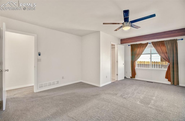 spare room with carpet and ceiling fan