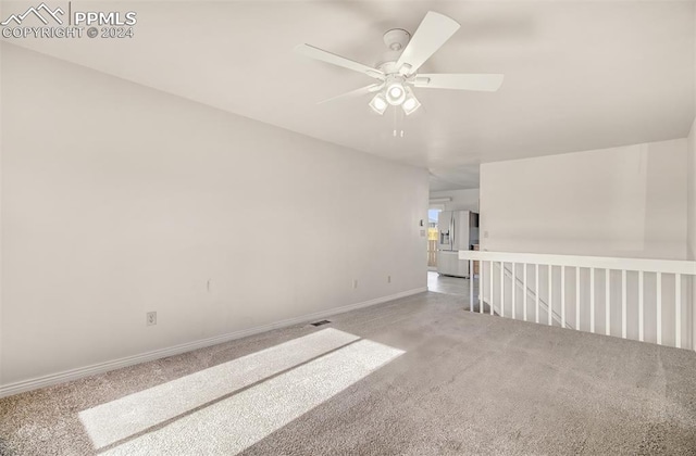 carpeted empty room with ceiling fan