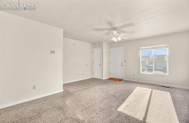 empty room featuring carpet flooring and ceiling fan