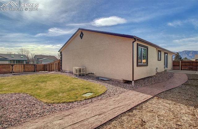 view of side of home with a yard