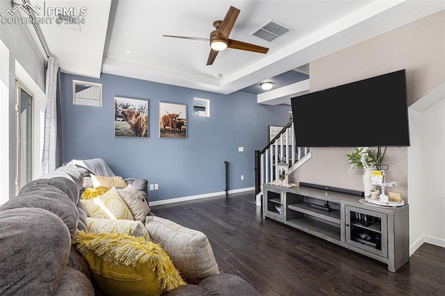 living room featuring ceiling fan and dark wood-type flooring