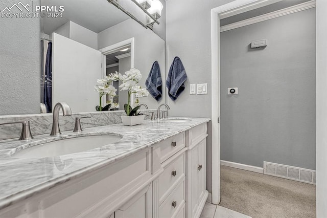 bathroom featuring vanity and ornamental molding