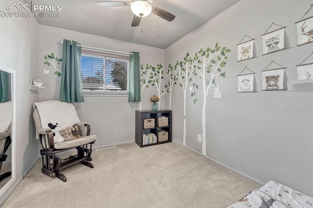 living area with light carpet and ceiling fan