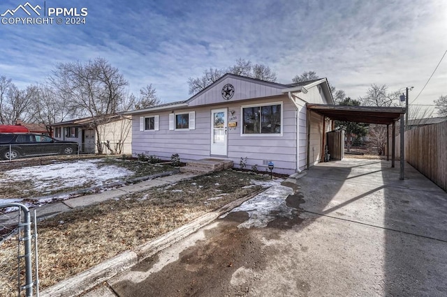 ranch-style home featuring a carport