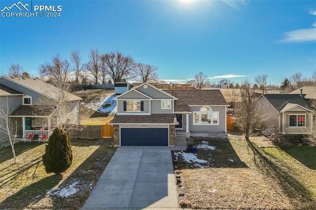 view of front of property with a front yard and a garage