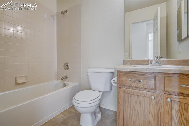 full bathroom featuring tile patterned flooring, vanity, toilet, and tiled shower / bath