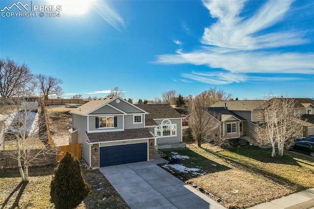 view of front of home featuring a garage and a front lawn