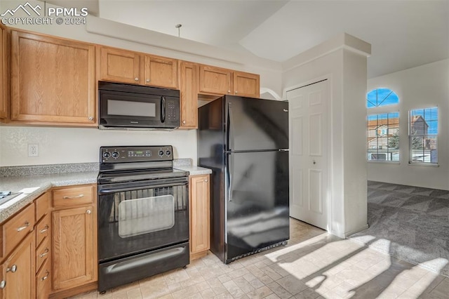 kitchen with light carpet and black appliances