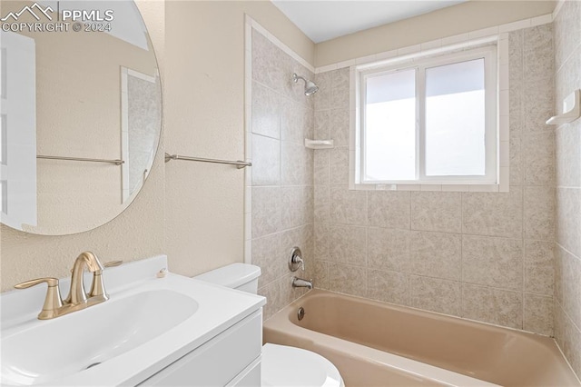 full bathroom with vanity, tiled shower / bath combo, and toilet