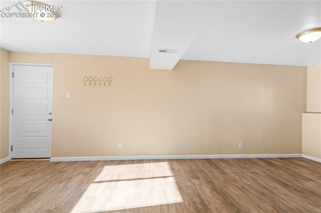 unfurnished room featuring hardwood / wood-style floors