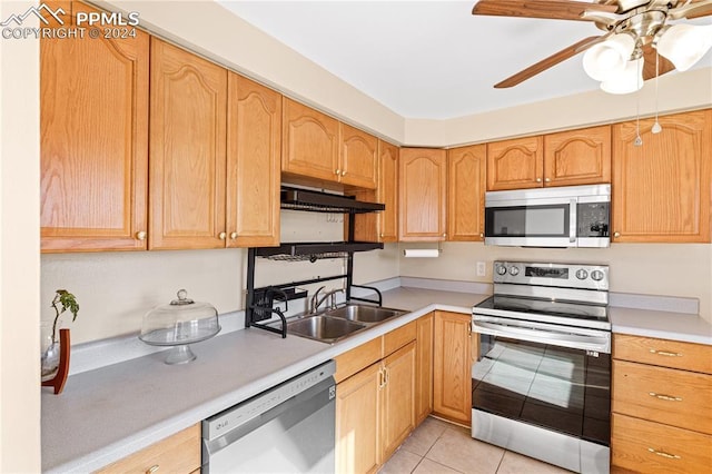 kitchen with ceiling fan, sink, ventilation hood, light tile patterned floors, and appliances with stainless steel finishes