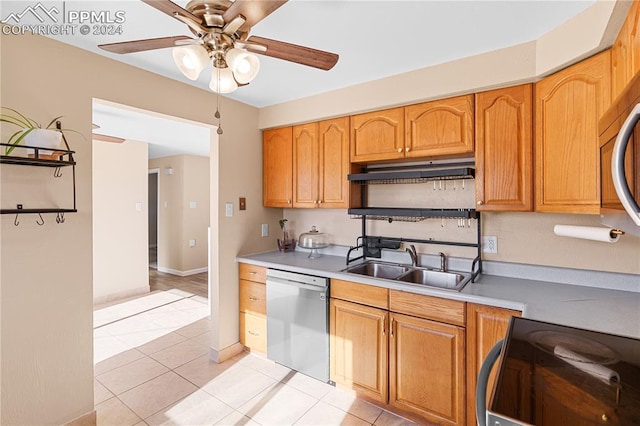 kitchen featuring ceiling fan, dishwasher, sink, light tile patterned floors, and range