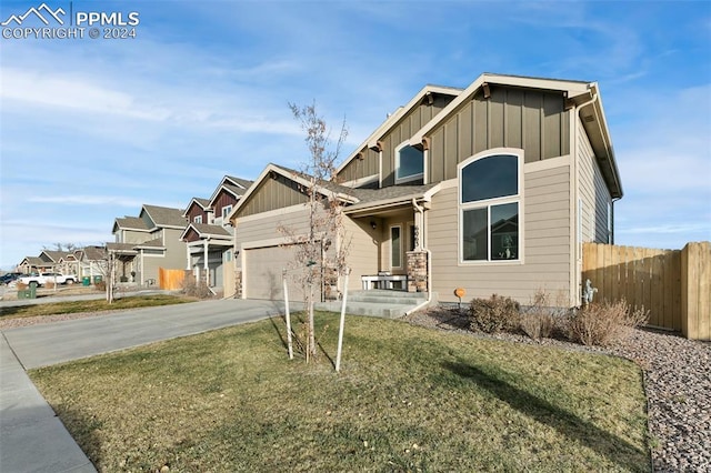 craftsman-style house featuring a garage and a front yard