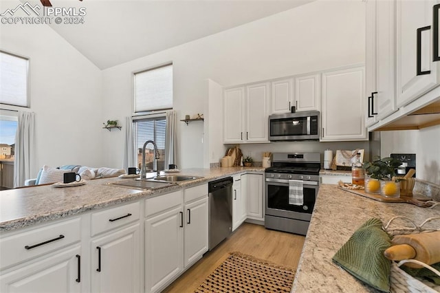 kitchen featuring sink, white cabinets, and appliances with stainless steel finishes